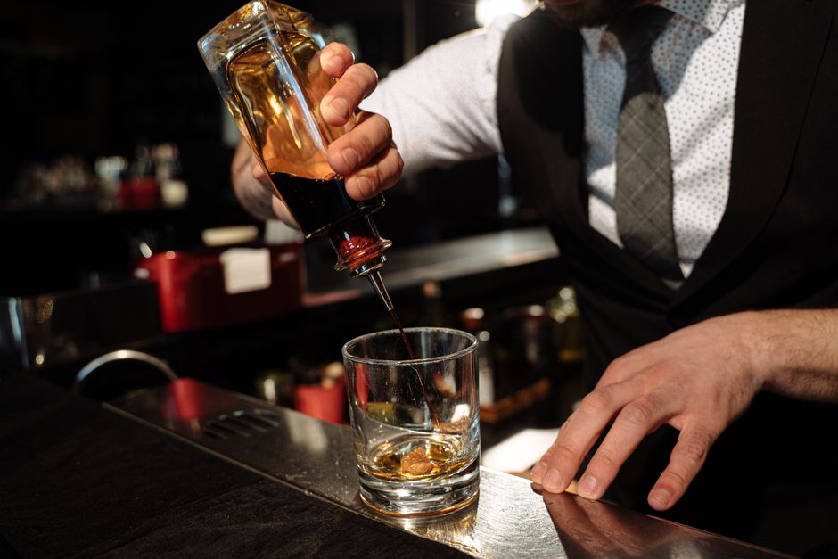 Bartender pouring craft cocktails for corporate event catering